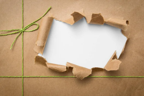 Package ripped on white background — Stock Photo, Image