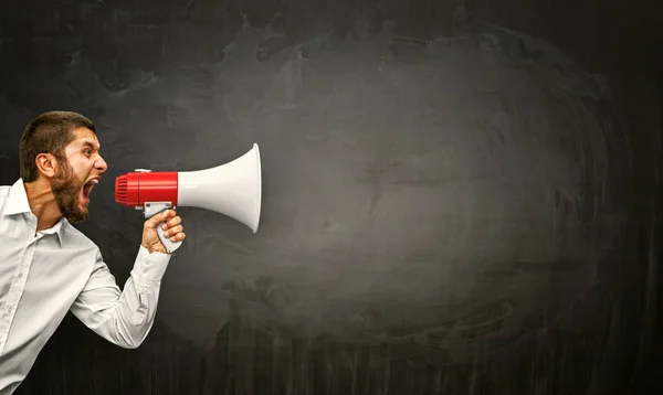 Businessman with megaphone in hand — Stock Photo, Image