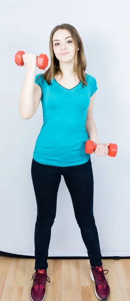 Girl with dumpbells on white background sport concept gym — Stock Photo, Image