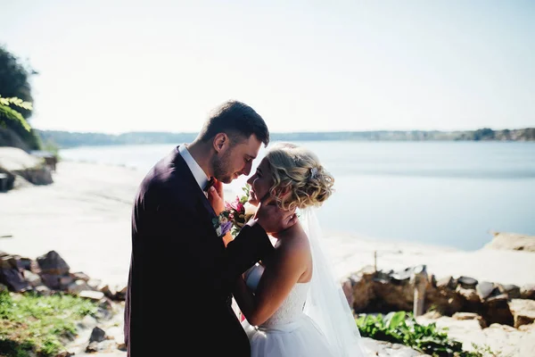 Sposa e sposo sparare e camminare lungo il fiume — Foto Stock