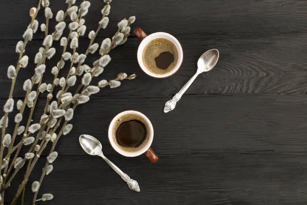 Black Coffee Two Brown Cups Willow Flowers Black Wooden Background — Stock Photo, Image