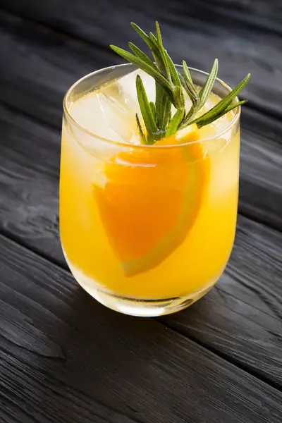 Orange Drink Lemonade Rosemary Ice Glass Black Wooden Background Closeup — Stock Photo, Image