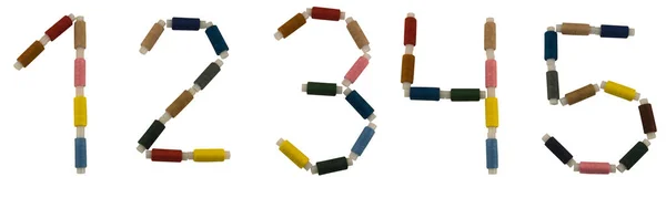 Izolált betűtípus set of numbers 1-5 made of colorful spools of thread for sewing — Stock Fotó