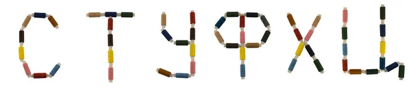 Geïsoleerde lettertype Russisch alfabet gemaakt van kleurrijke spoelen van garen voor het naaien — Stockfoto