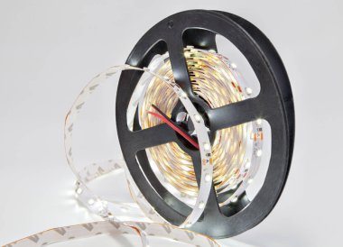 Closeup shine garland LED tape on plastic coil.