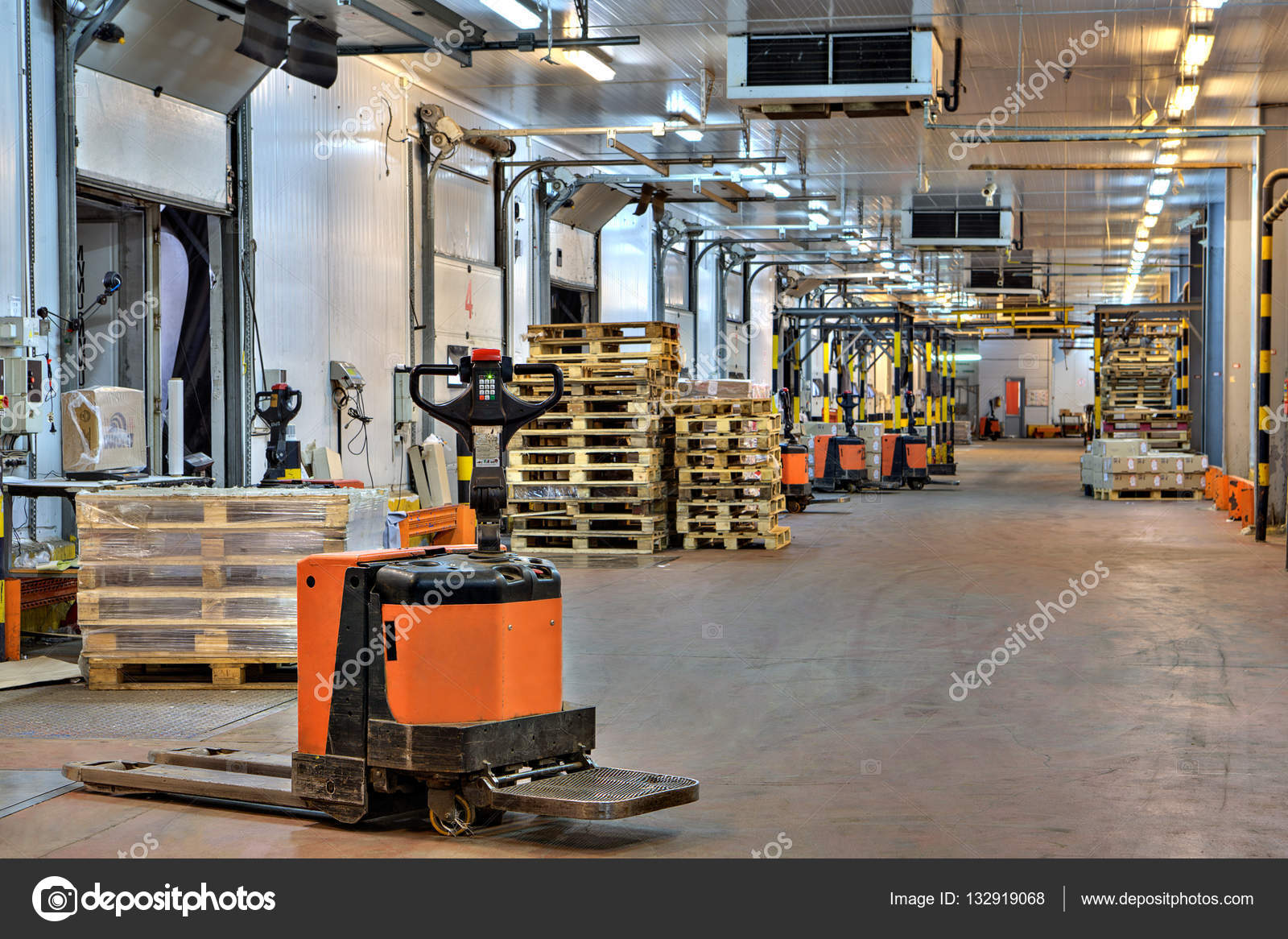 Forklifts pallet truck in loading dock inside cold storage warehouse