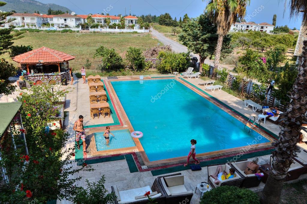 Swimming pool, barbecue area with bar in small hotel. Stock Editorial
