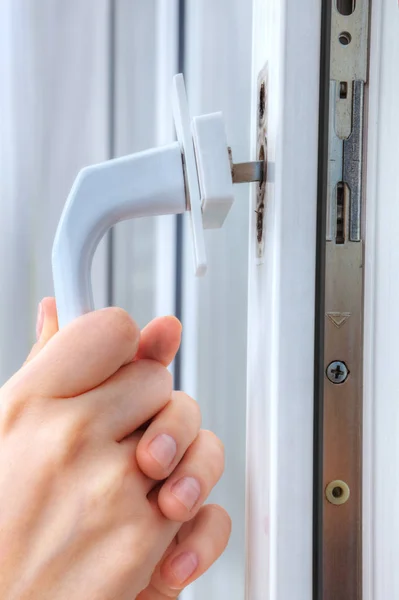 Hands locksmith  remove the handle of window frame, close-up. — Stock Photo, Image