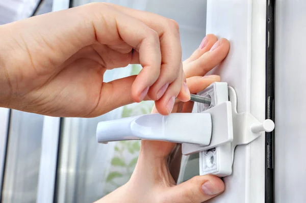 Installer installs  limiter for PVC window, he screwed screw, cl — Stock Photo, Image