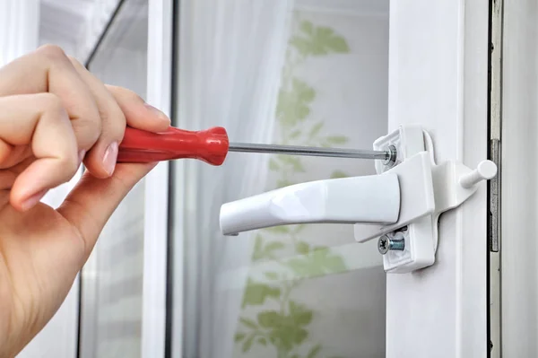 Install limiter for  plastic window, using a screwdriver, close- — Stock Photo, Image