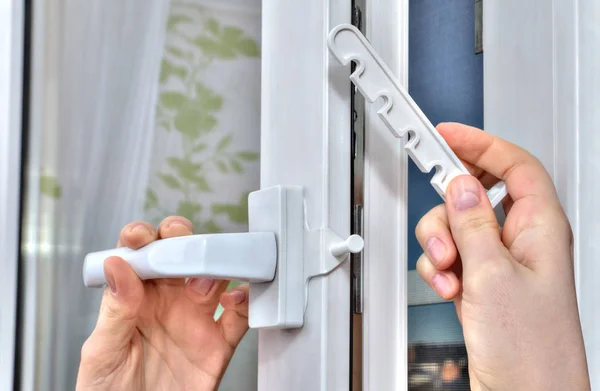 Mounting opening restrictor for PVC window, close-up. — Stock Image Mounting opening restrictor for PVC window, close-up. Stock Image