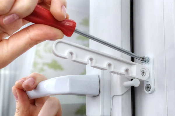 Close-up, fixing of the opening limiter on plastic window. — Stock Image Close-up, fixing of the opening limiter on plastic window. Stock Image