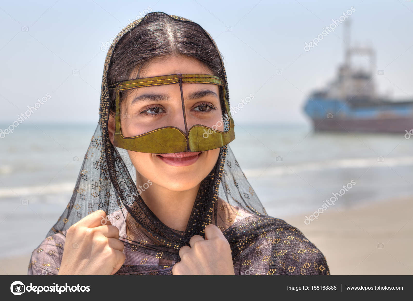 Iranian girl in traditional Muslim mask of southern Iran, smilin Stock