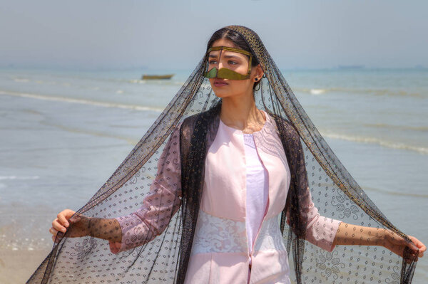Young muslim woman wears gold mask, Hormozgan province, southern