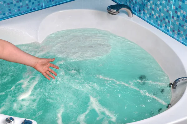 Nahaufnahme einer Hand, die das Wasser im Whirlpool berührt. — Stockfoto