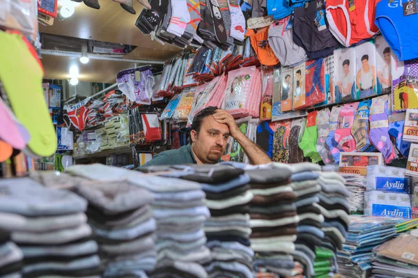 Underwear store inside bazaar, Iranian seller waiting for buyers, Shiraz, Iran. — Stock Photo, Image