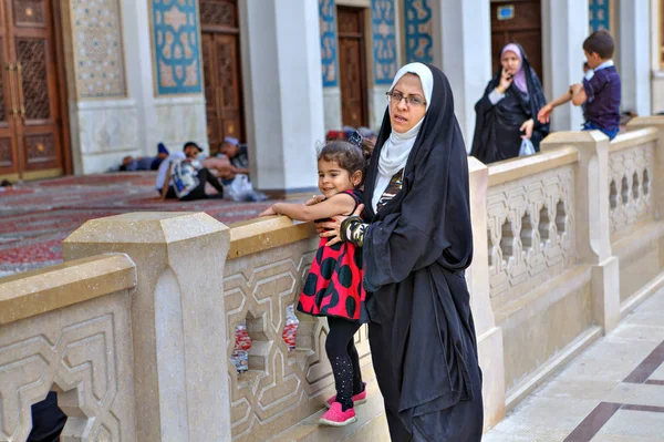 Mãe caminha com sua filhinha no pátio da mesquita, Shiraz, Irã . — Fotografia de Stock