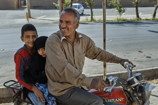 Gyerekek lovagolni egy motorkerékpár édesapjukkal, Yazd, Irán. — Stock Fotó