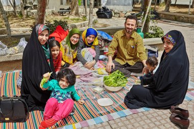 Iranian family on a picnic in the park, Tehran, Iran. clipart