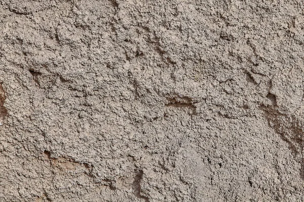 Eine Wand mit grobem Kalkputz von grauer Farbe. — Stockfoto