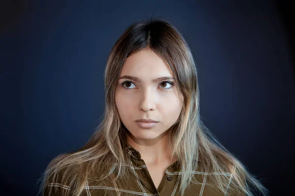 An incredulous sidelong glance of a young woman.