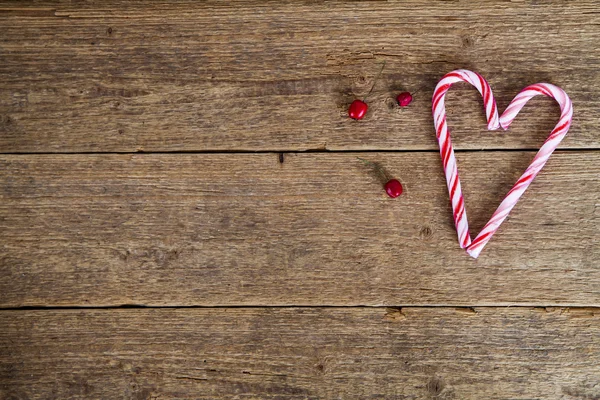 Background with candy canes in the shape of heart — Stock Photo, Image