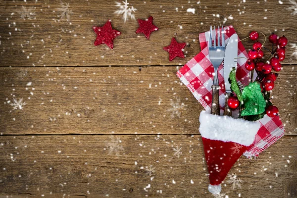 The cutlery on the woodwn table in santa hat — Stock Photo, Image