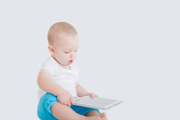 Годовалый ребенок играет на планшете — стоковое фото