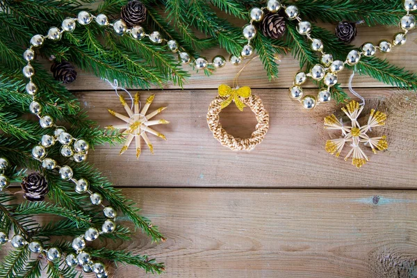 Branch of fir with decorations on wood — Stock Photo, Image