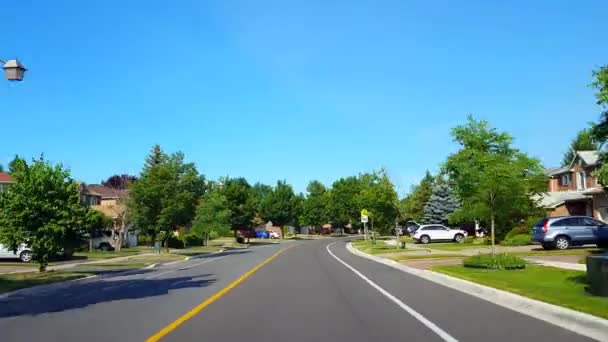 Reverse Motion Driving Approaching Stop Sign Residential City Road Lush — Vídeo de Stock