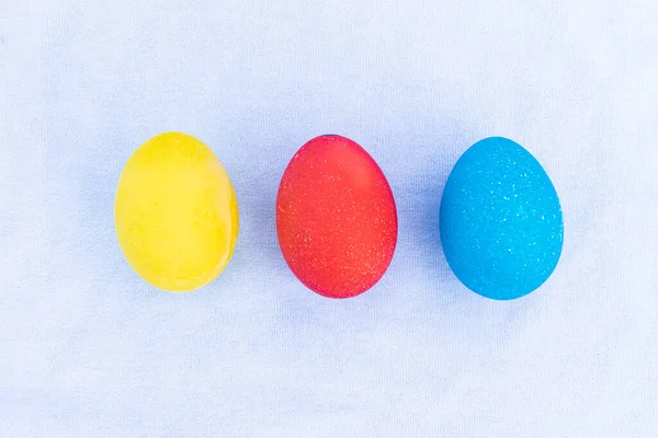 Three Multicolored Eggs Lie Row Light Blue Background Set Homemade — Stock Photo, Image