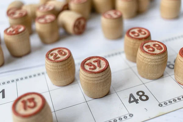 Board game lotto or bingo. Wooden lotto barrels on game cards. The concept of leisure at home in isolation with the family. Interesting fun pastime