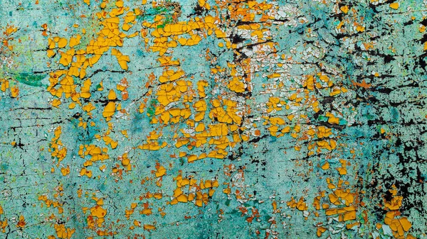Gammal gul och blå sprucken färg på väggen — Stockfoto