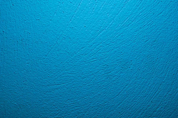 Wall painted in blue with visible plaster texture — 스톡 사진