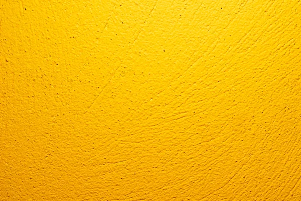 Parede pintada de amarelo com textura de gesso visível — Fotografia de Stock