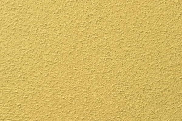 Parede pintada em amarelo com textura de gesso visível — Fotografia de Stock