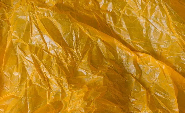 orange wrinkled foil bag. texture or background