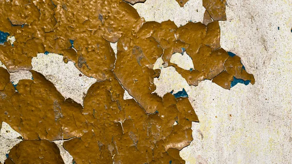 old orange paint peeling off the wall.