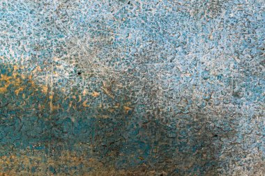 Eski bir duvar görünür detaylarla maviye boyanmış.