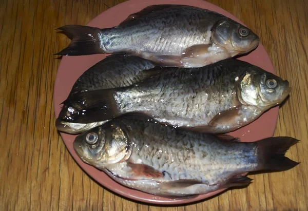 Three fish crucian on a plate — Stock Photo, Image