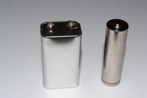 Duas baterias em um fundo cinza — Fotografia de Stock