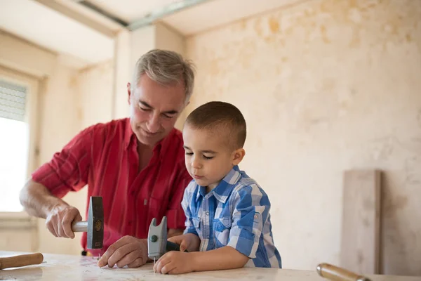 Grandfather and grandson in workshop — Stock Photo, Image