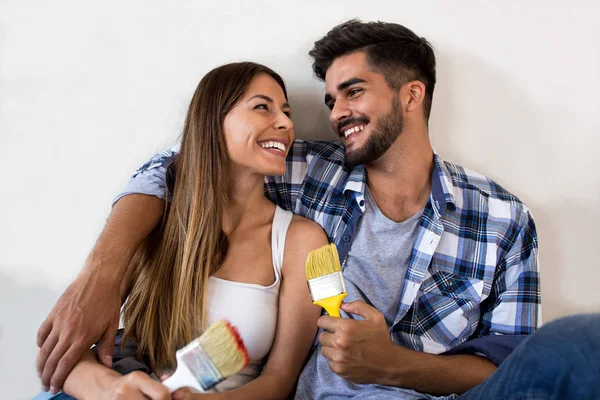 Relaxing after hardwork painting their home — Stock Photo, Image