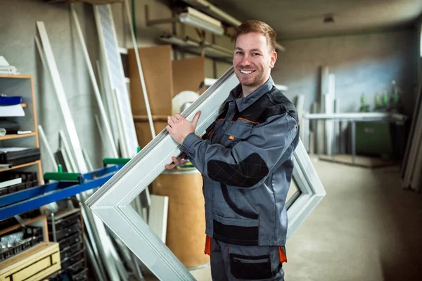 Worker in workshop for manufacture of windows and doors