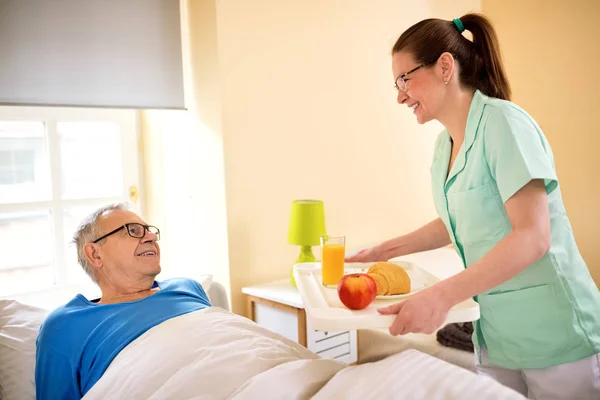 Smiling happy senior patient waiting breakfast at nursing home — Stock Photo, Image