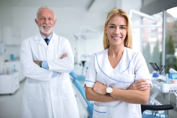 Two smiling dentists in a dental office — Stock Photo, Image