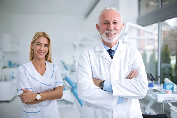 Two smiling dentists in a dental office — Stock Photo, Image