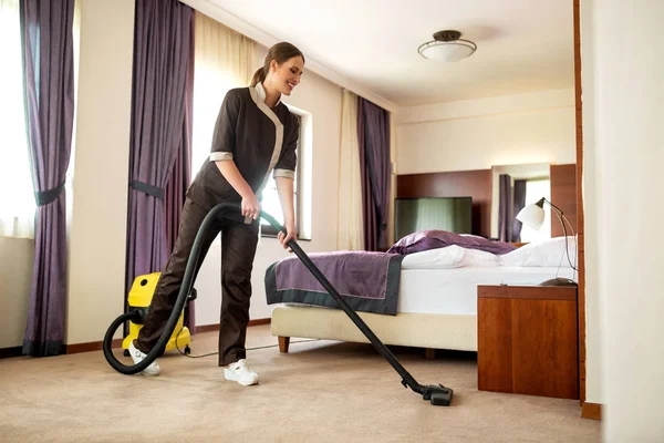 Hotel cleaning service maid vacuuming — 스톡 사진