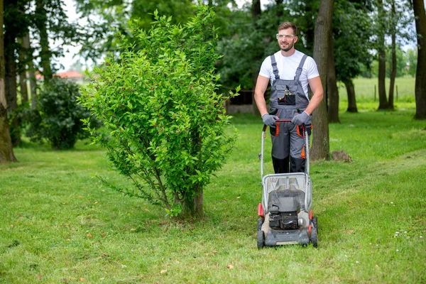 Handsome man dressed in lawn mowing outfit — Stock Photo, Image
