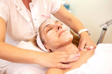 Applying of moisturizer cream all over the face